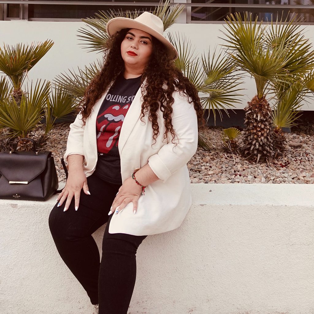 Plus-size woman wearing blazer and graphic tee