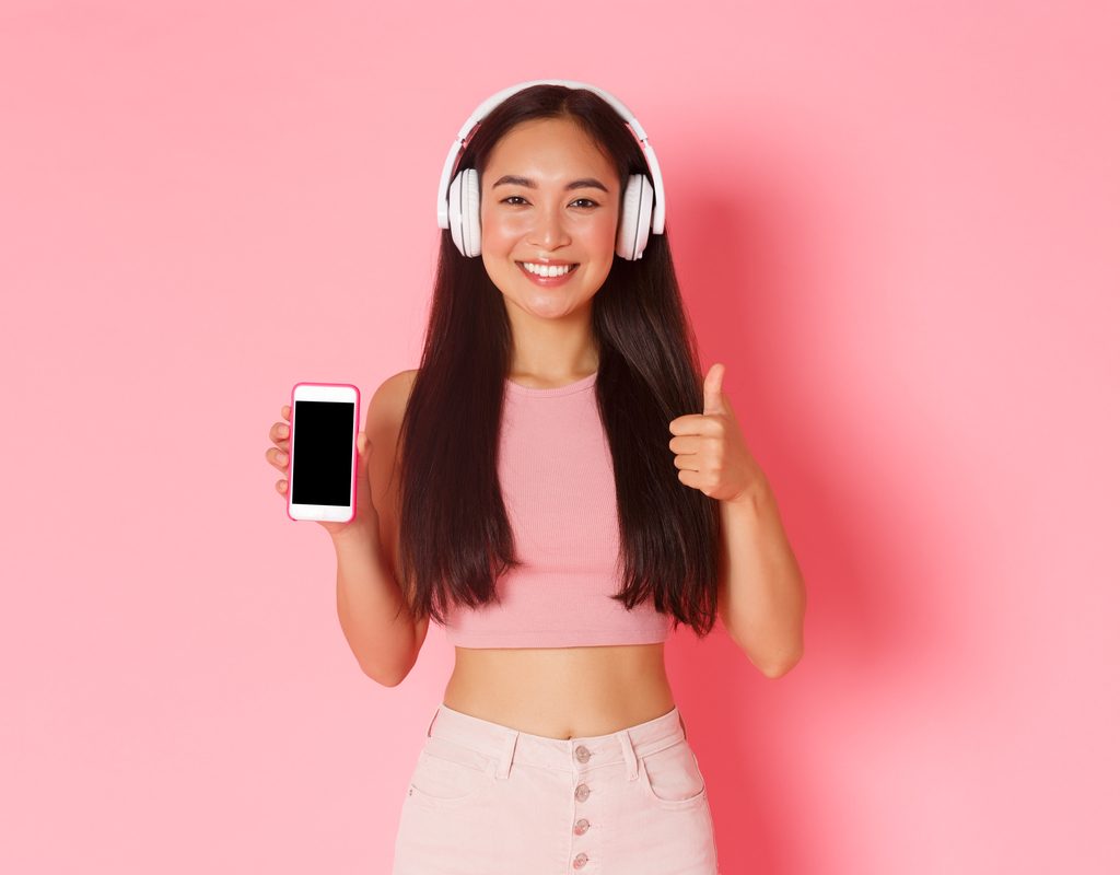 A woman listening to a podcast on her phone.