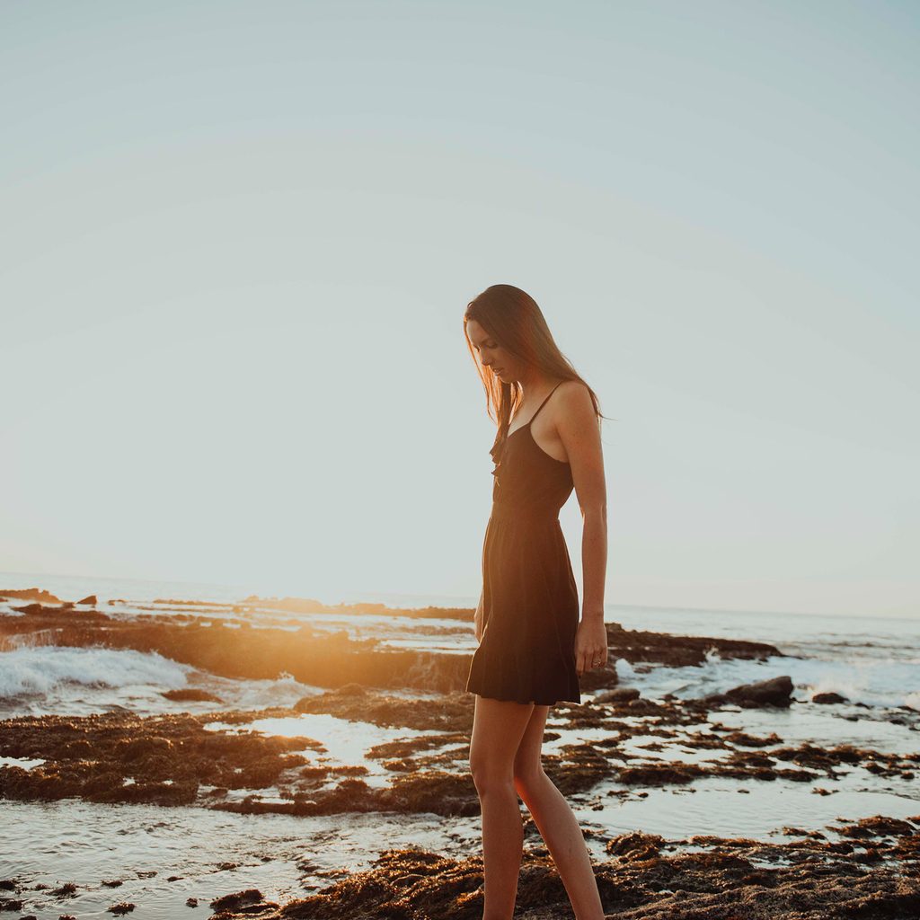 Tall woman in a dress on a beach