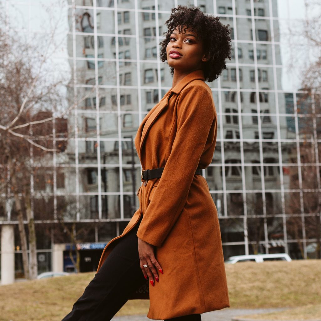 Tall woman wearing a trench coat