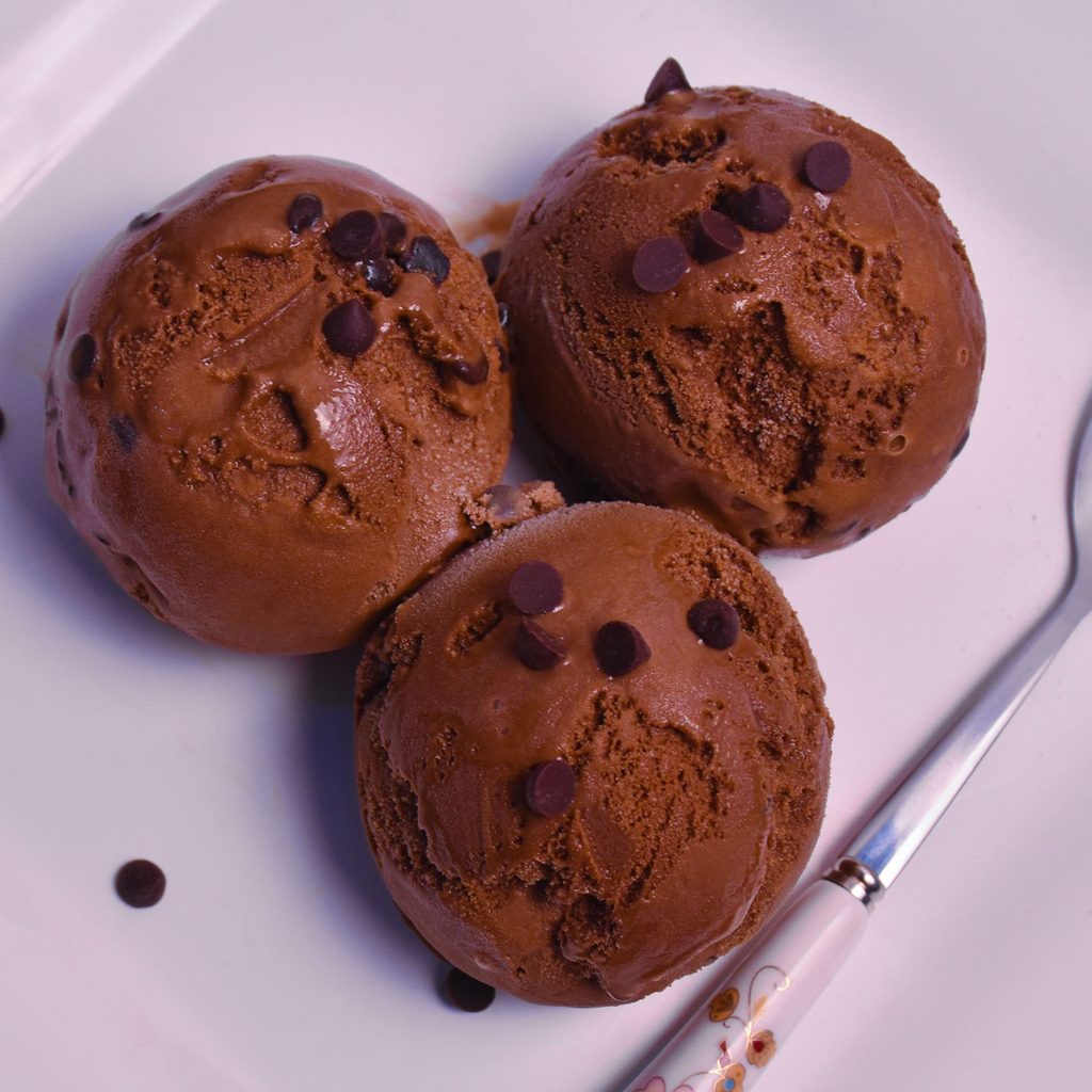 Three scoops of chocolate ice cream on a plate