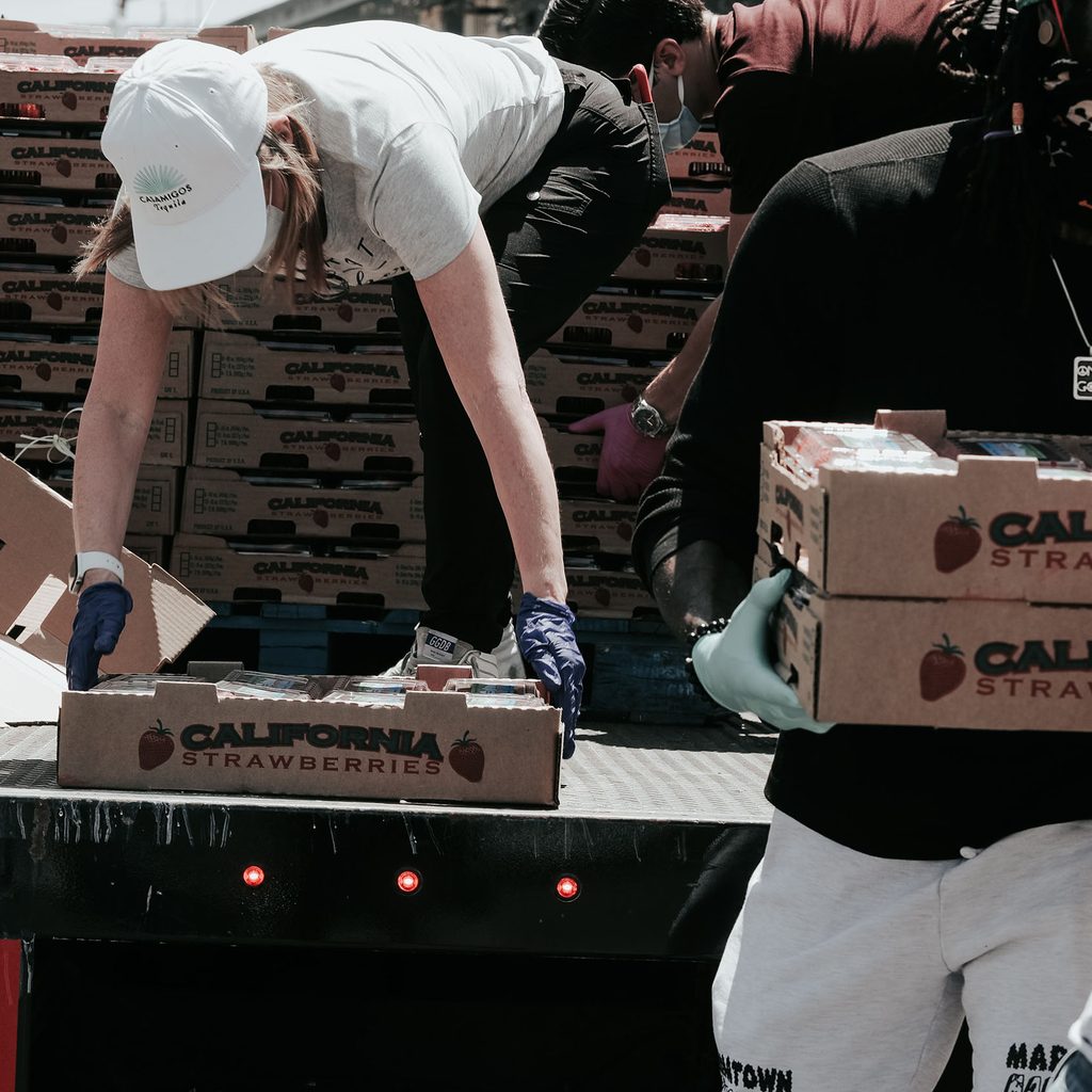 Volunteers unloading donated food from a truck