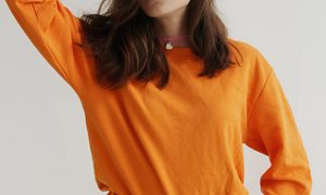Woman wearing an orange long-sleeve shirt