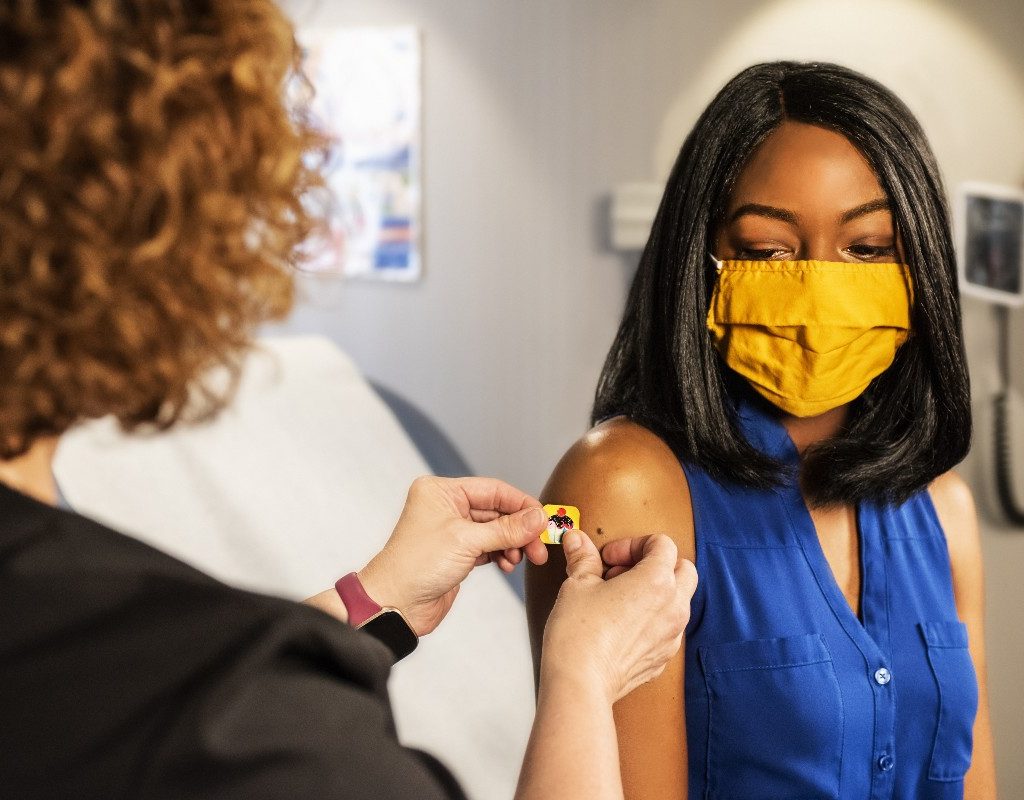 a woman receiving her covid-19 vaccine