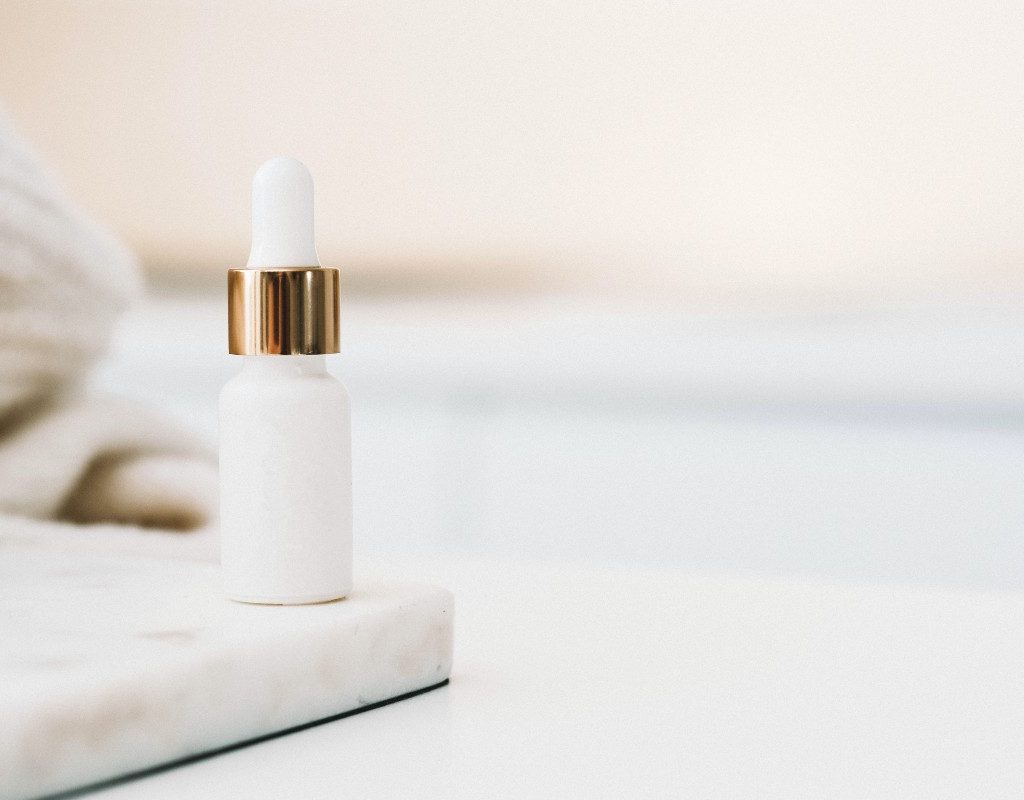 a beauty product in a white bottle on a white counter