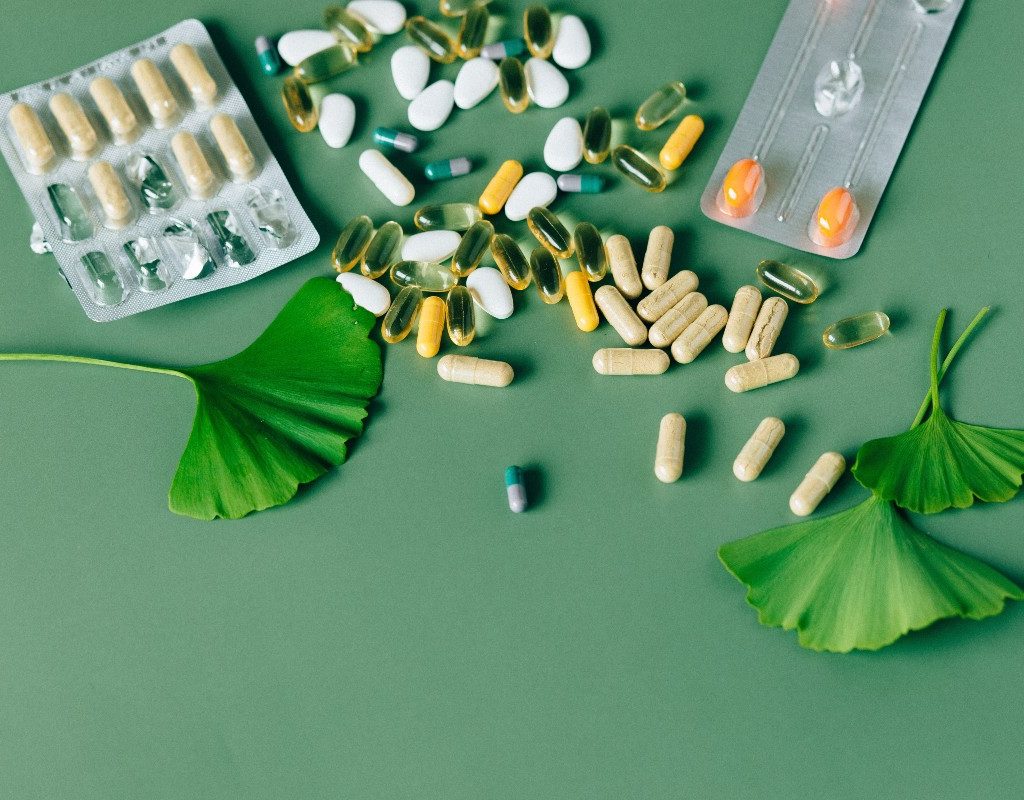 a flatlay of supplements on a green background