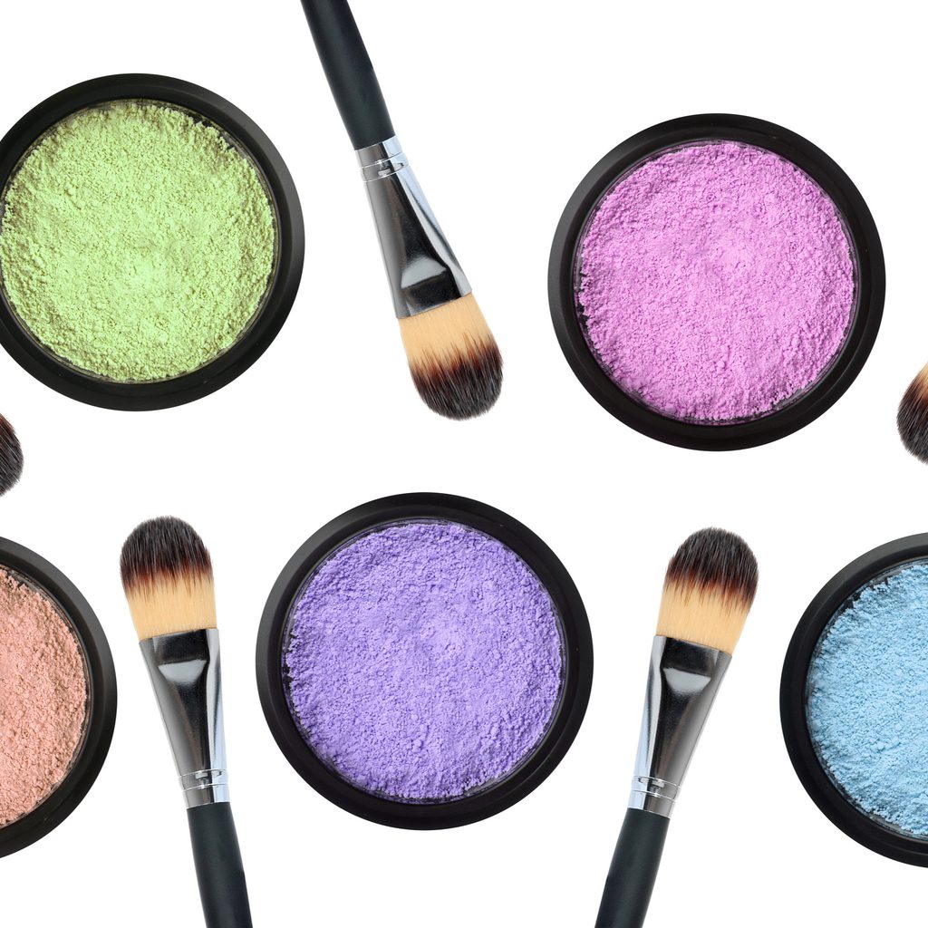 Grouping of pastel-colored eyeshadows with brushes