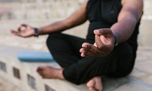 a person meditating outside
