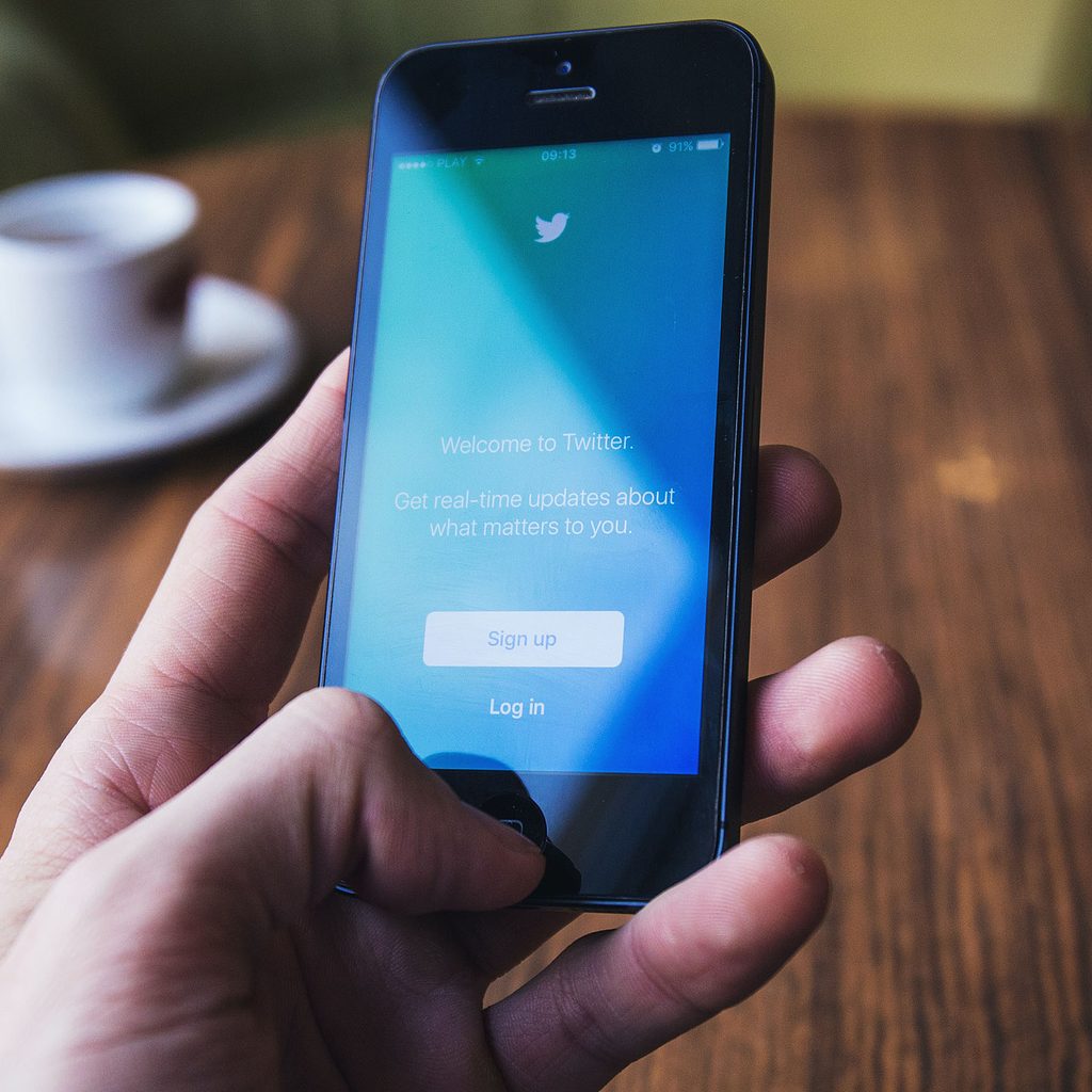 Person looking at Twitter on a phone