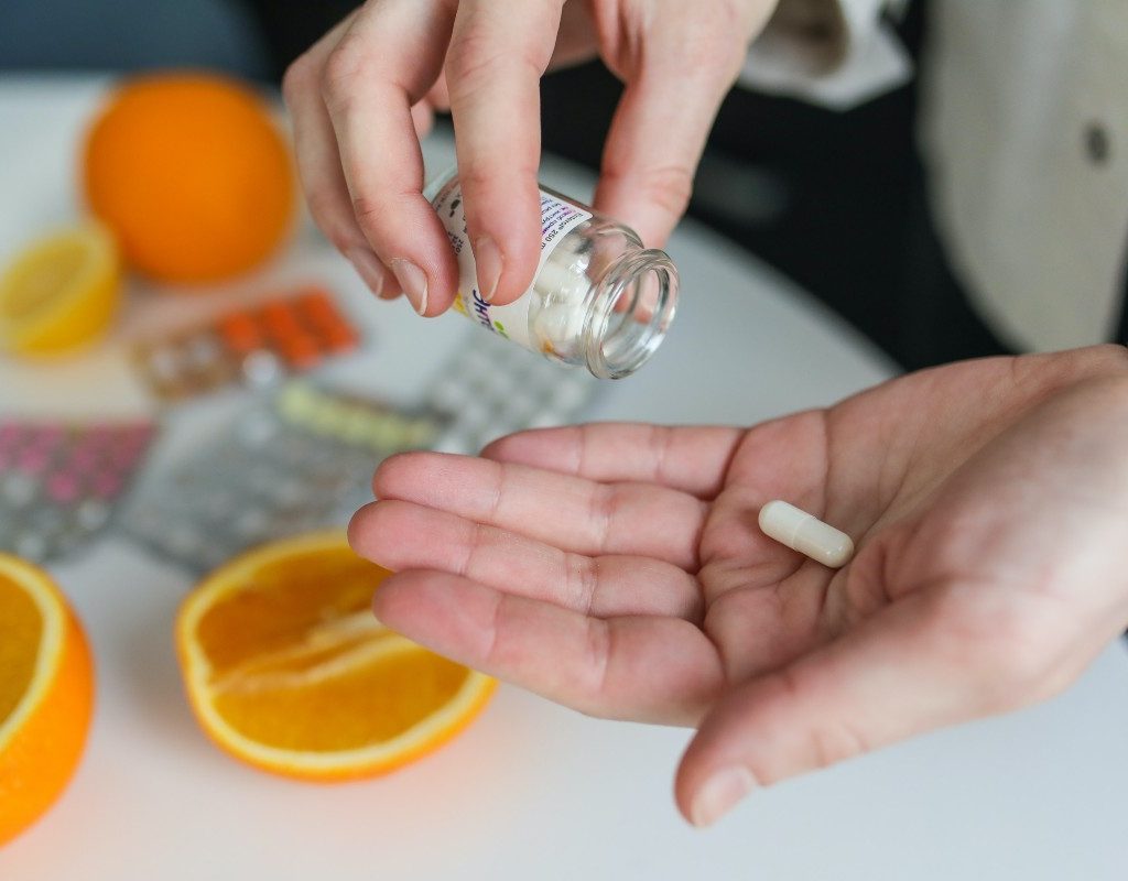 a person taking a supplement