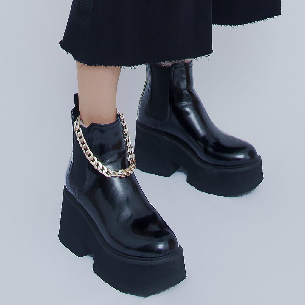 Person wearing black platform boots