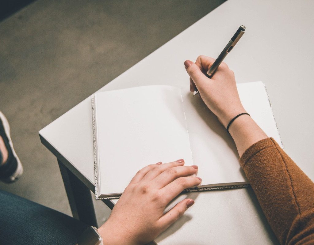 a person writing in a notebook