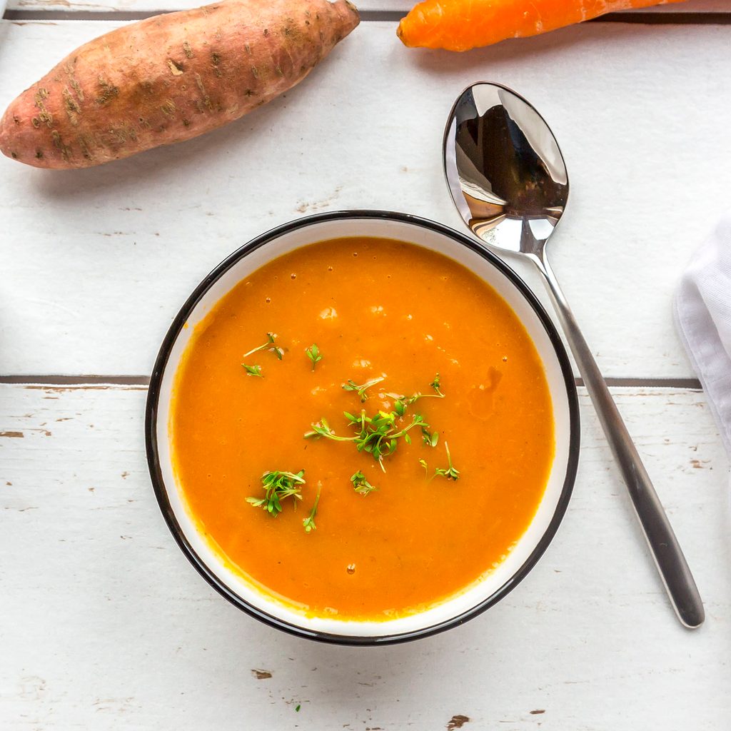 Sweet potato soup with ladle and ingredients