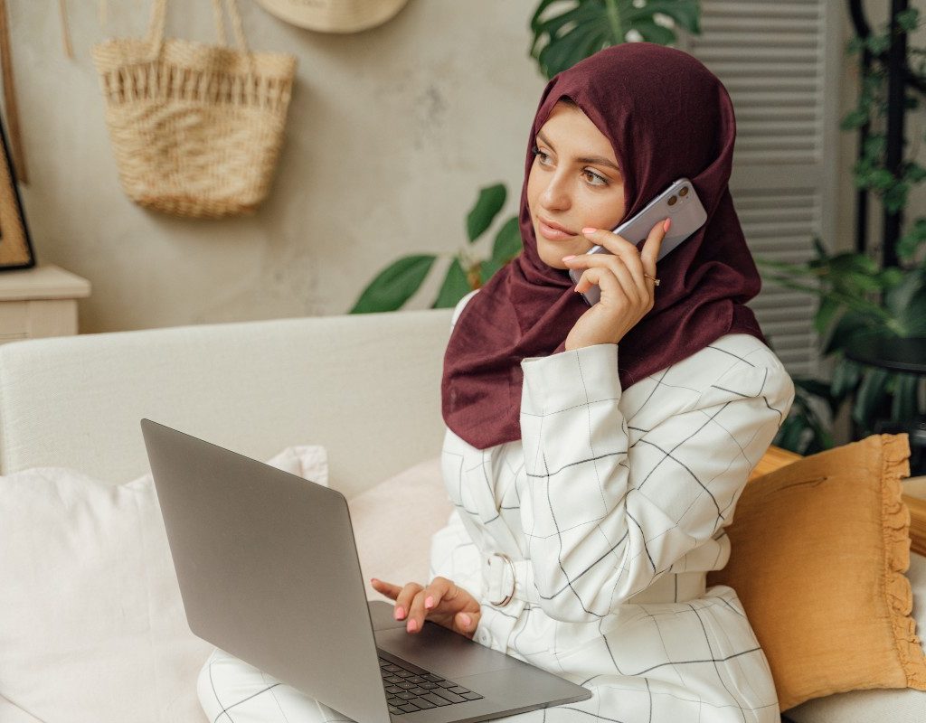 a woman on her phone and computer