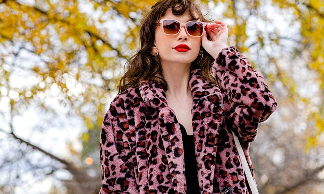 Woman wearing a faux fur pink leopard print coat