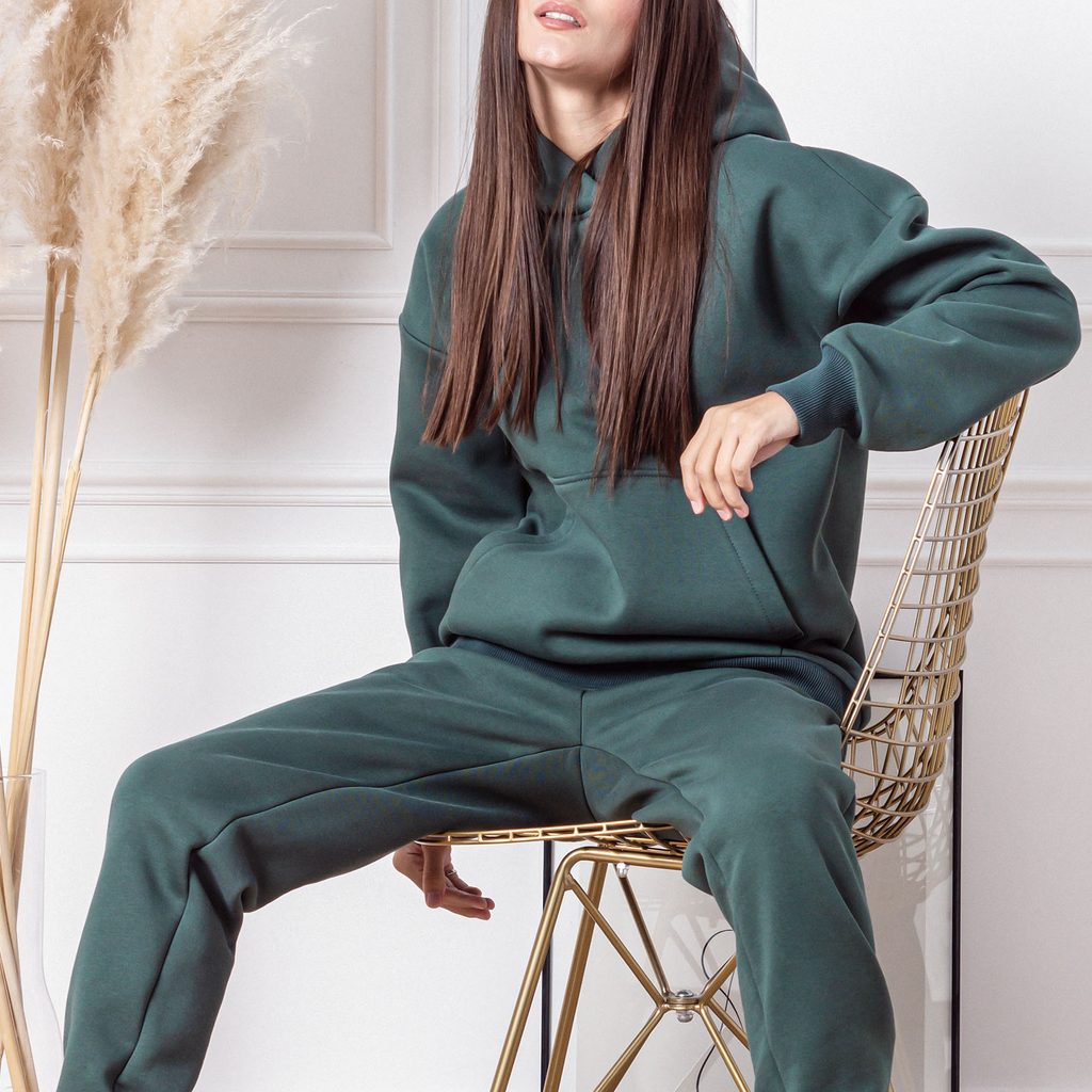 Woman wearing a dark green monochromatic sweatsuit
