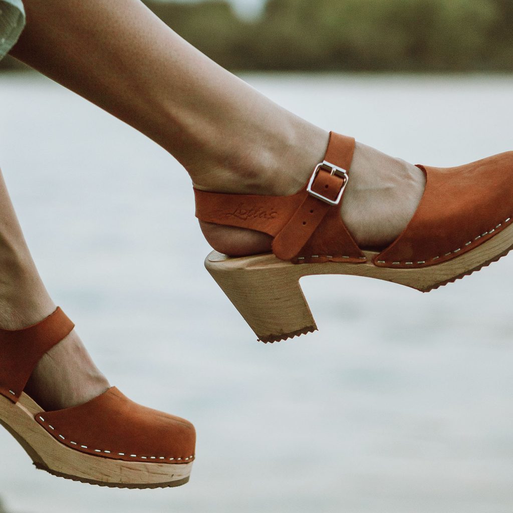 Woman wearing heeled clogs