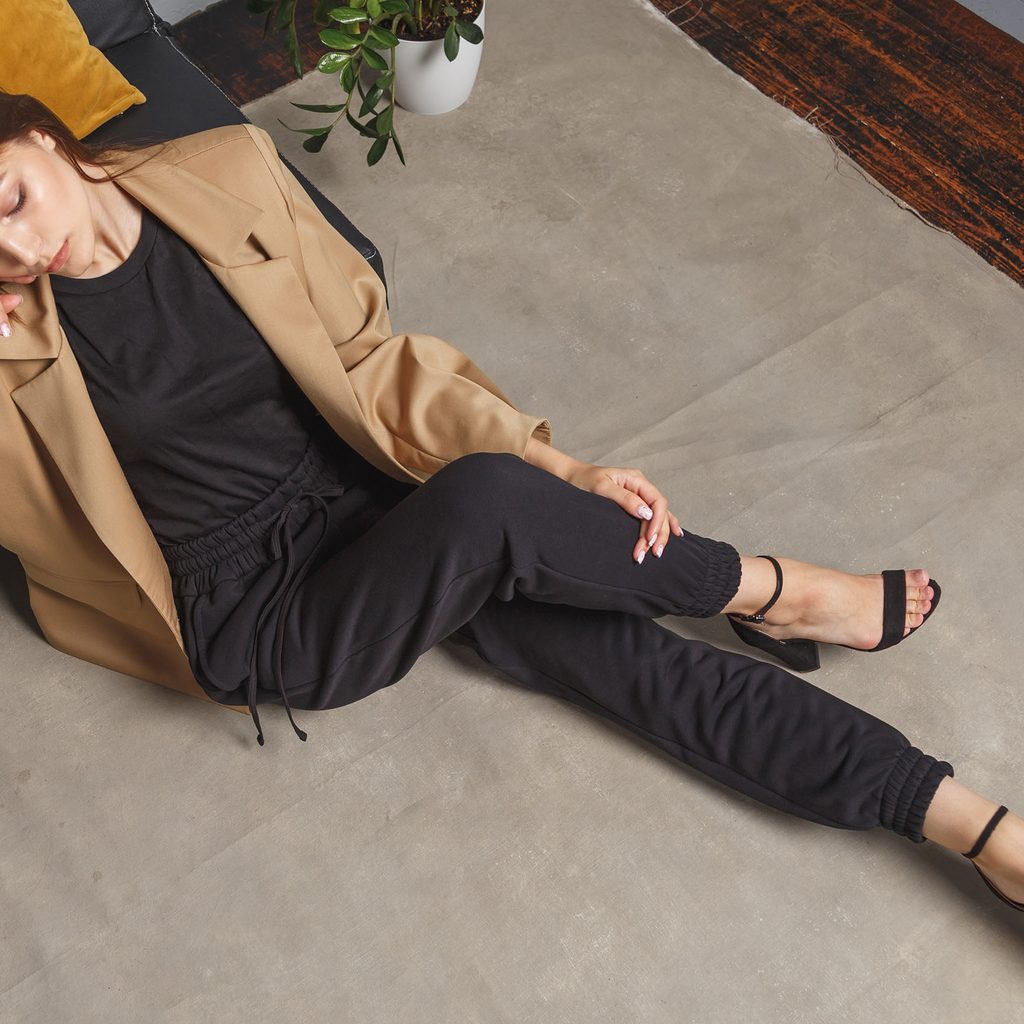 Woman wearing sweatpants, a blazer, and heels