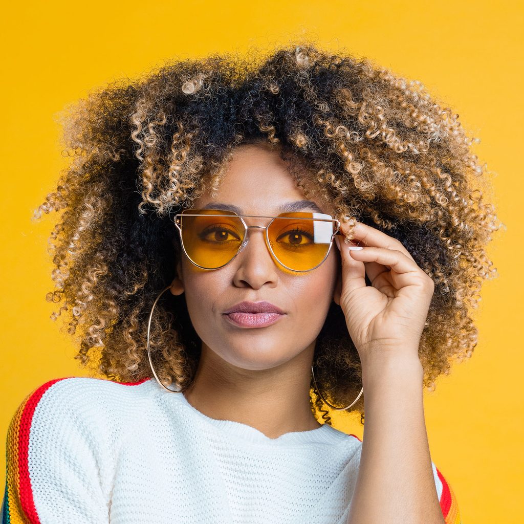 Woman with afro wearing tinted sunglasses