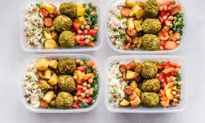 Four containers of healthy food.