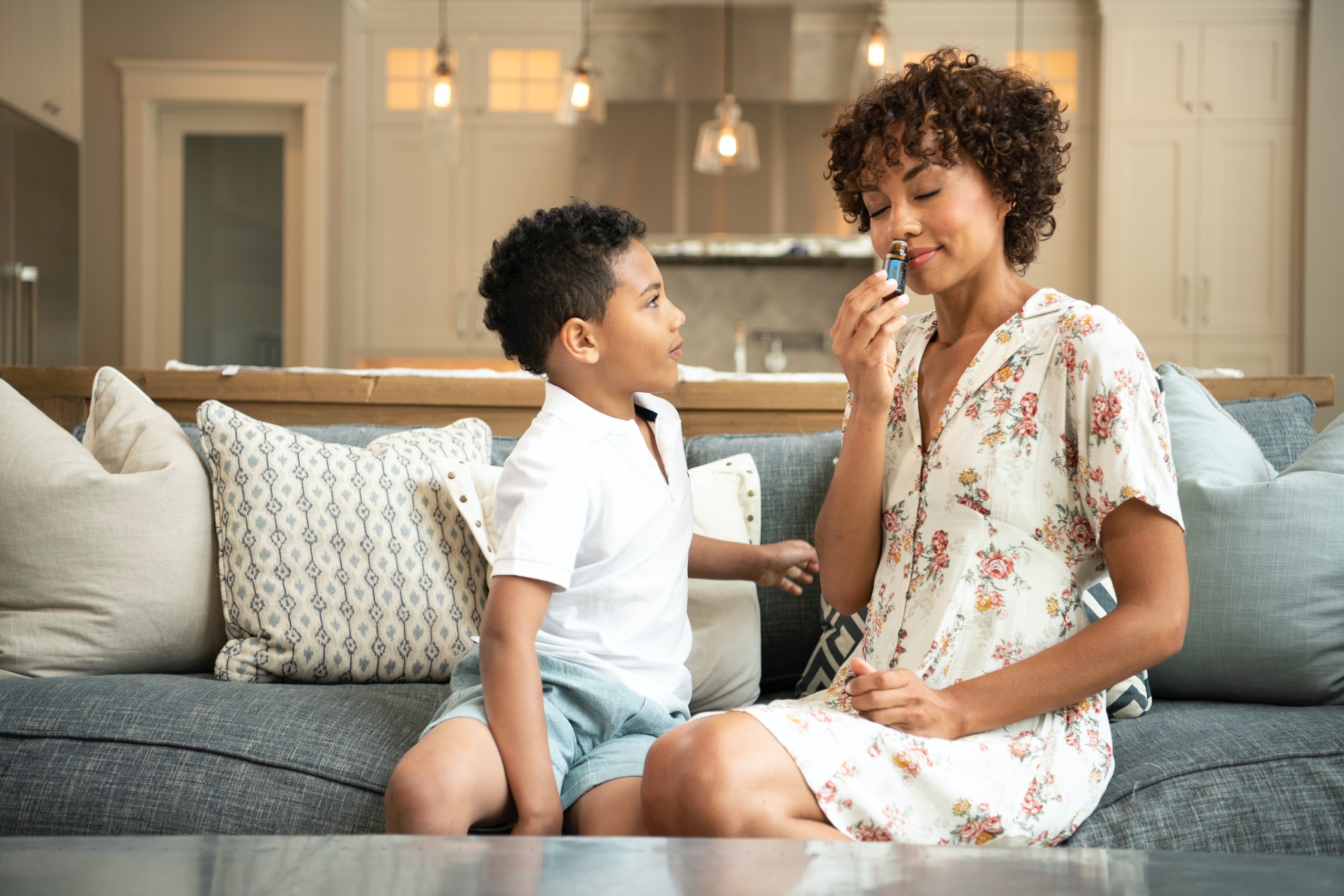 Mother and Son Smelling a Bottle of Essential Oil
