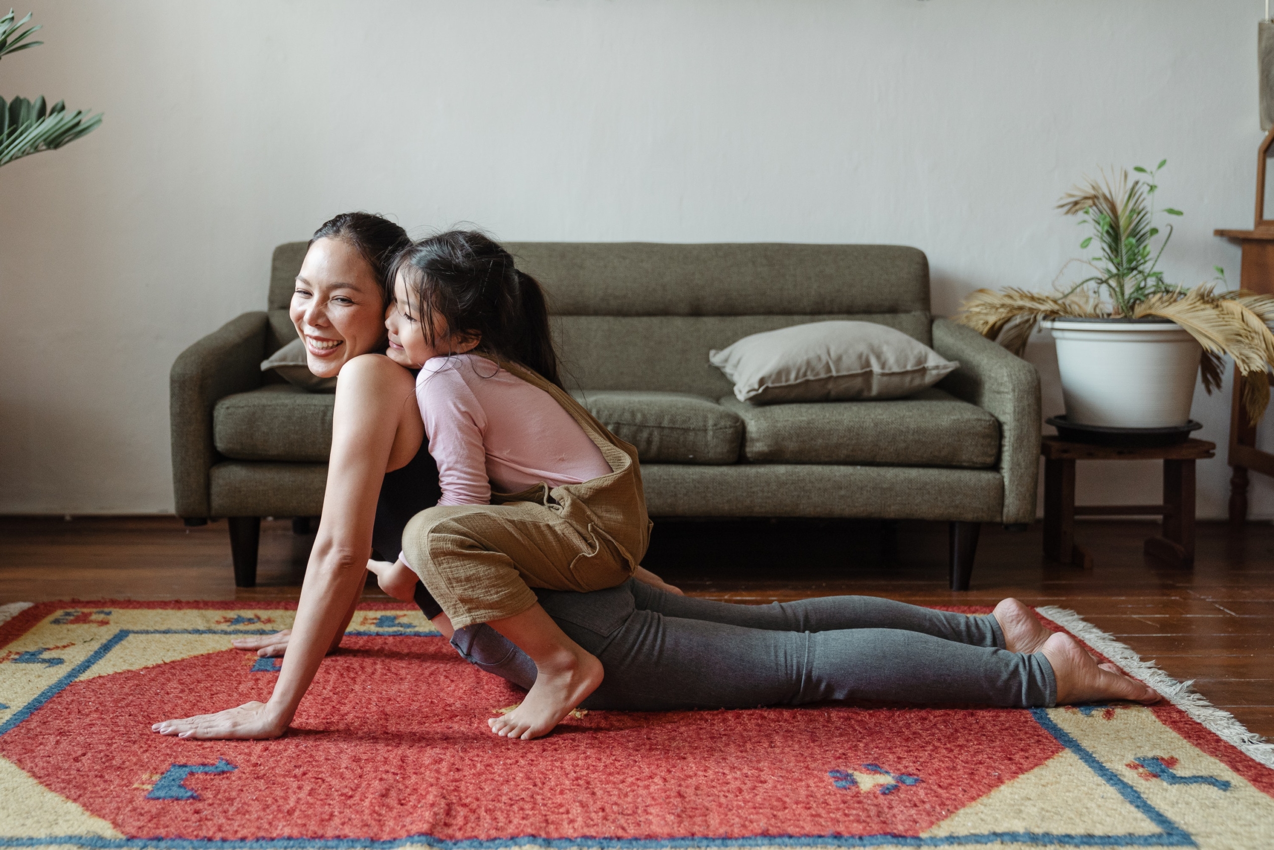 Girl Hugging Mom While Doing Yoga