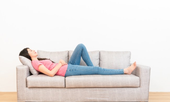 heartburn symptom management woman lying down couch