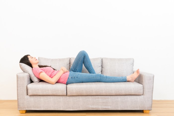 heartburn symptom management woman lying down couch