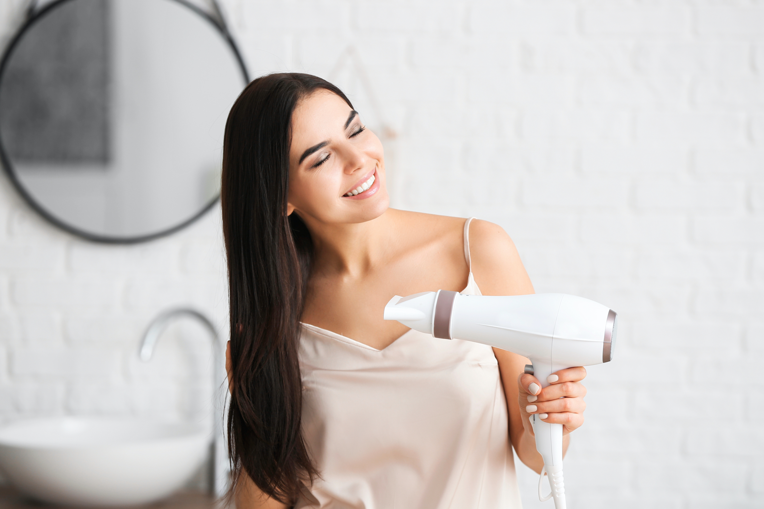 Woman blowdrying her hair