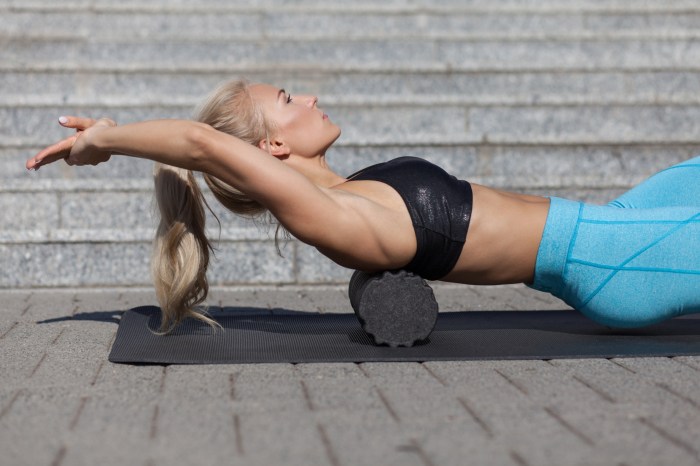 woman performing lower back exercises with foam roller