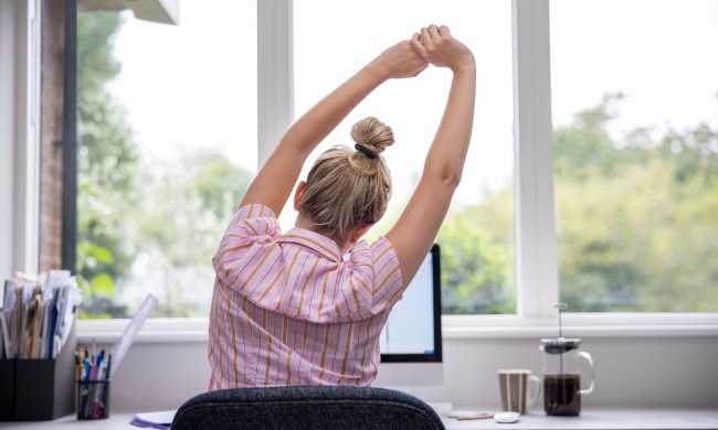 woman stretching at her desk