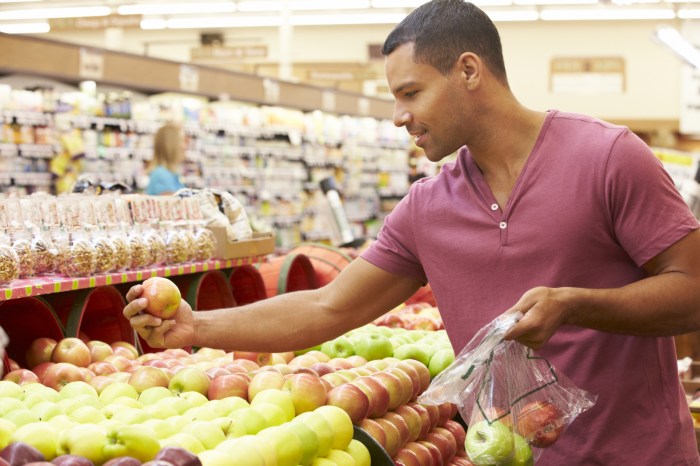 man shopping in grocery store for produce