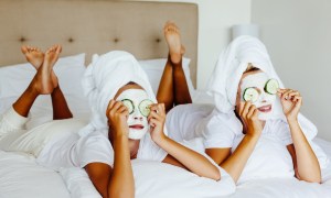 two women wearing face masks and towels