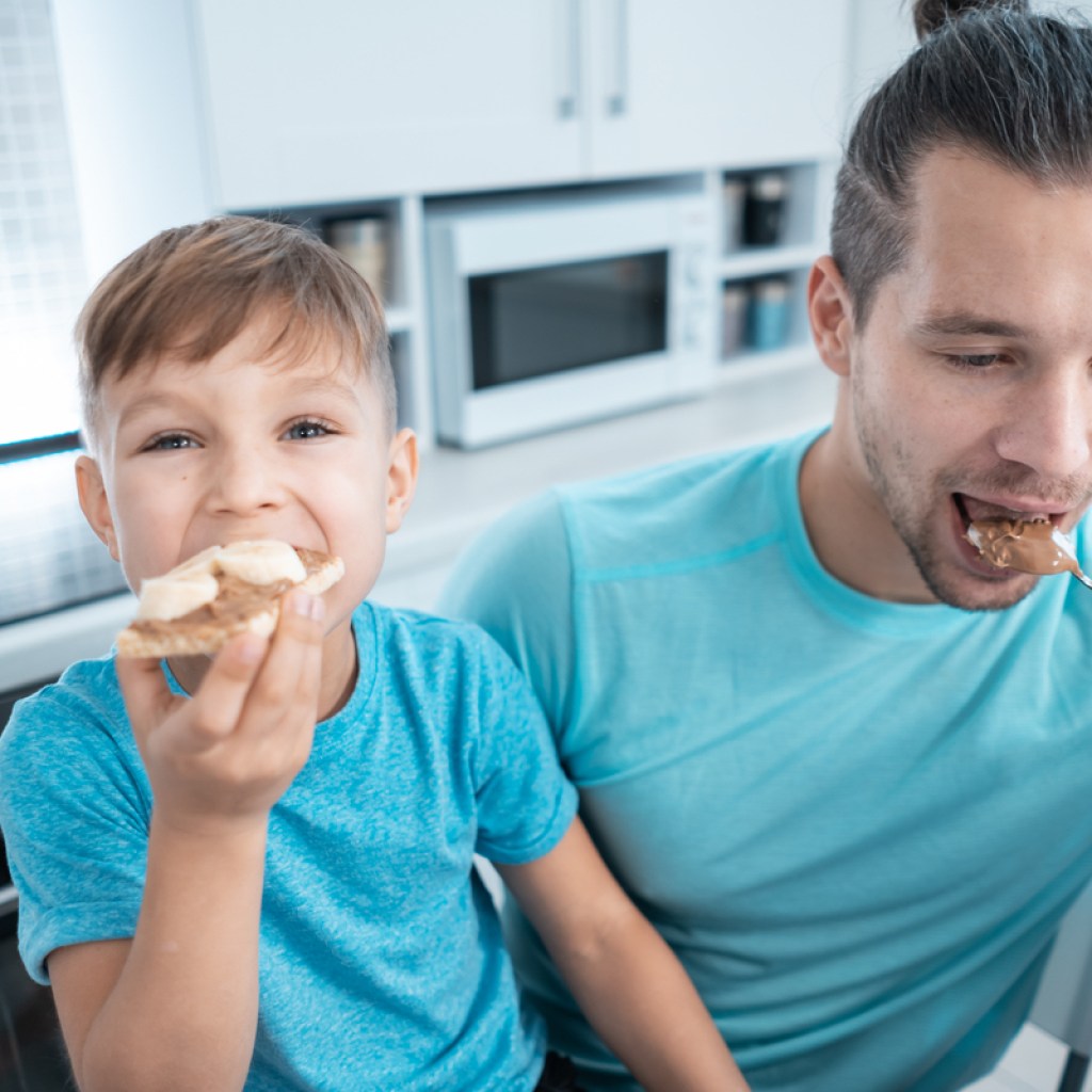 A father and son eat no-nut butter