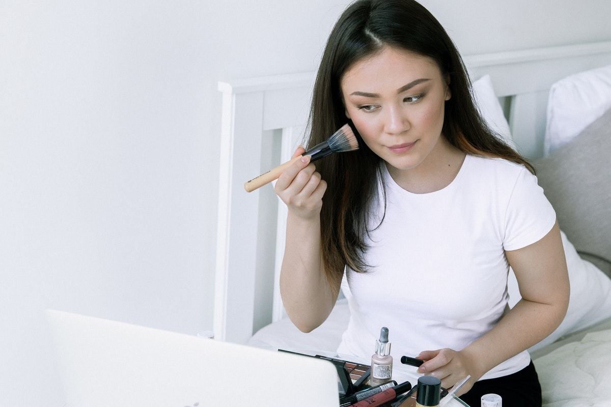A woman applying her makeup