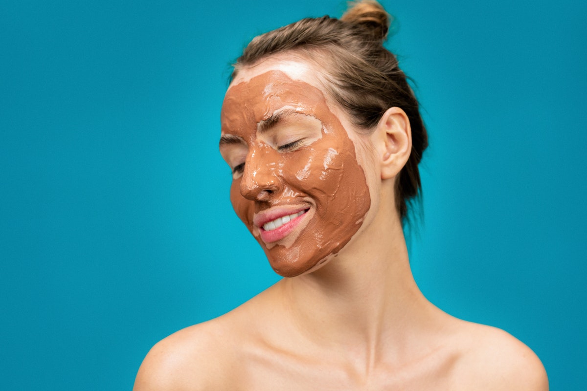 A woman with a mud mask on