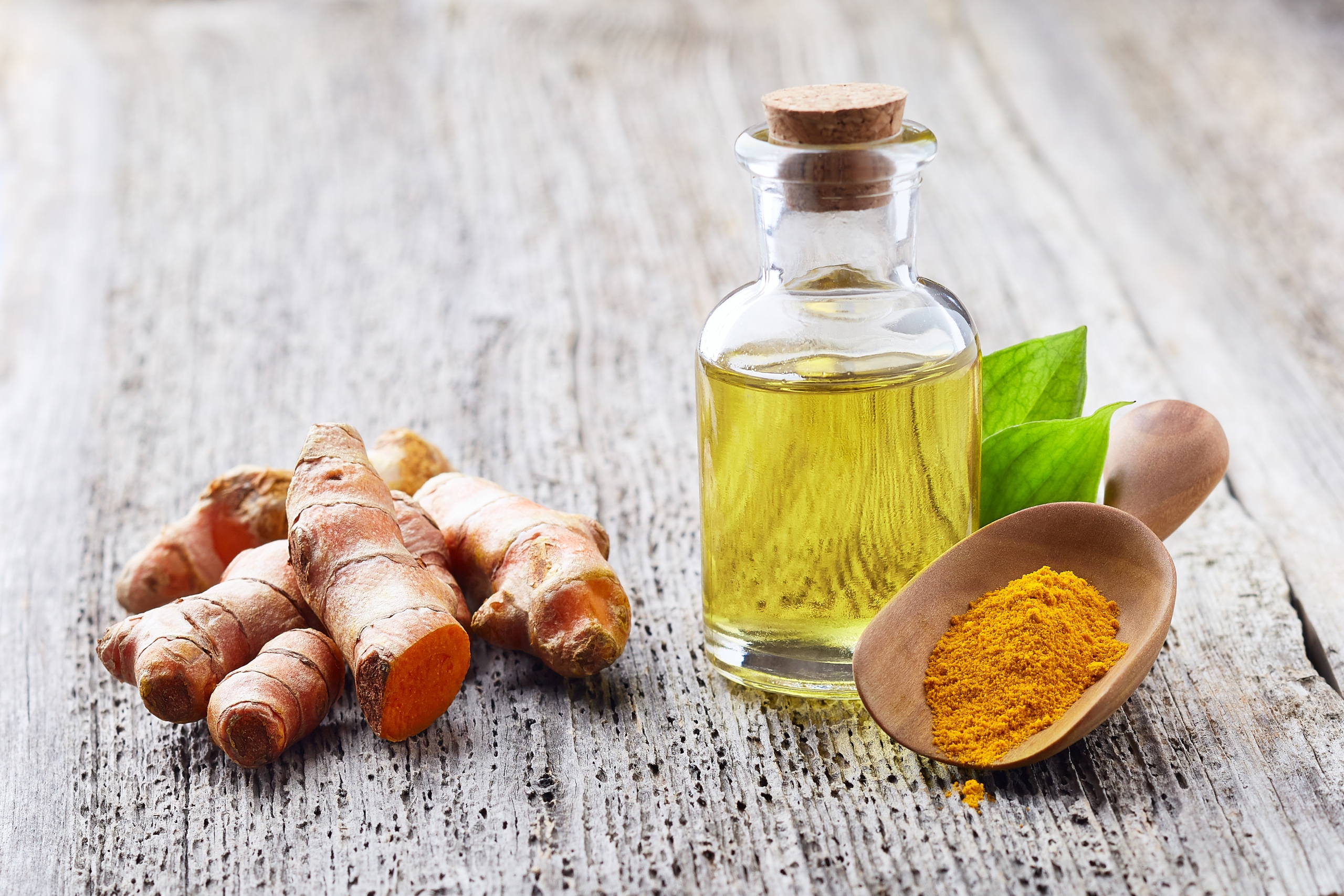 turmeric root essential oil on table