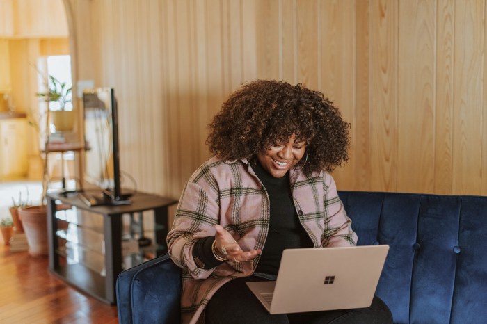 Woman happily using laptop