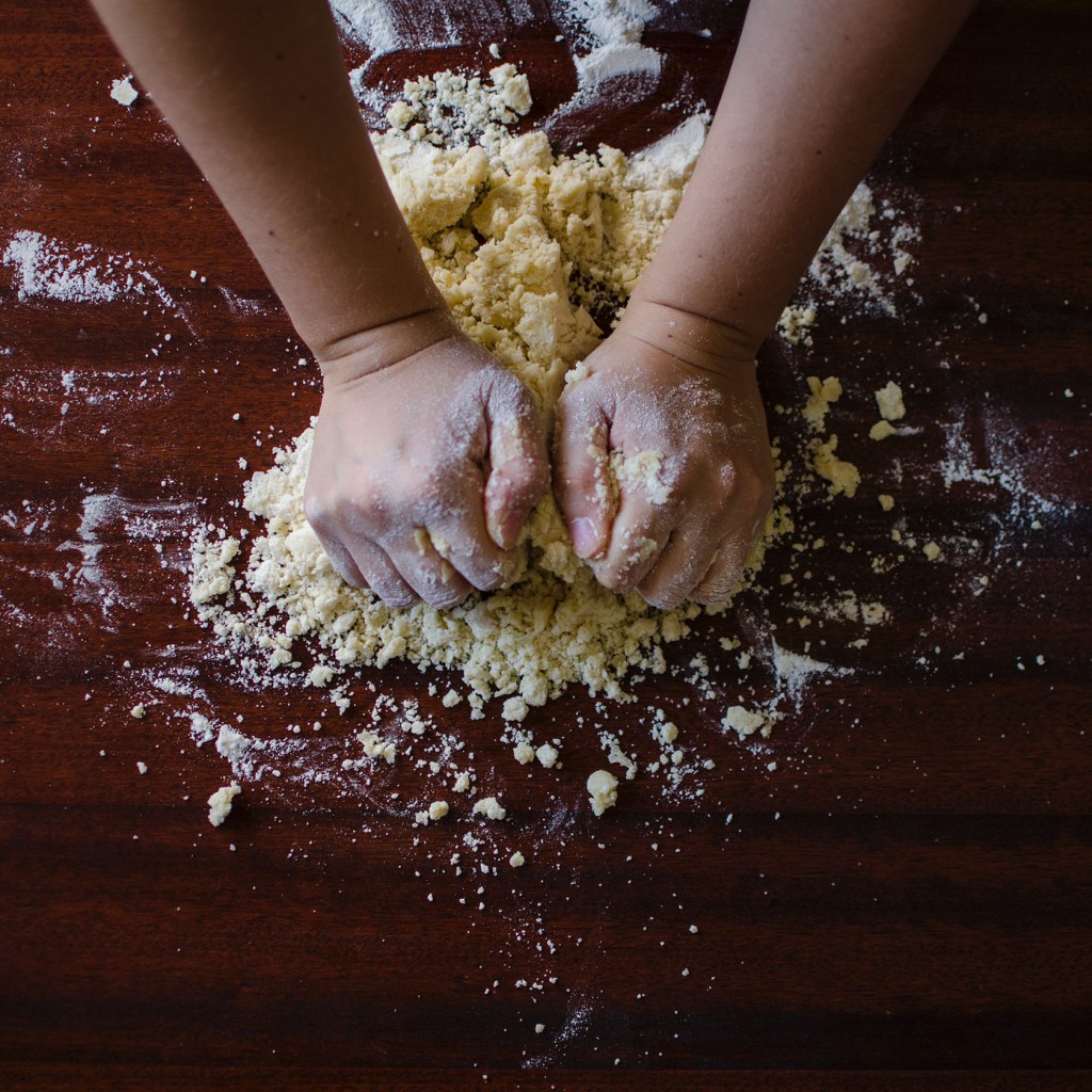 Woman baking, kneading dough