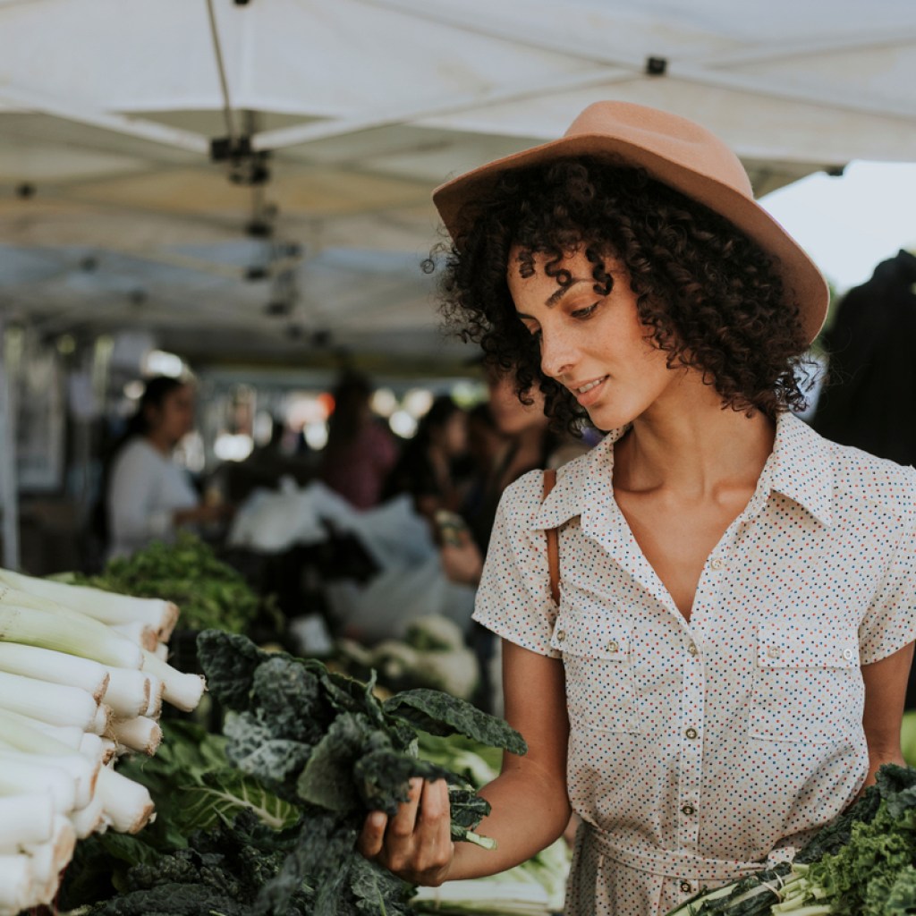 A woman shops for leafy greens