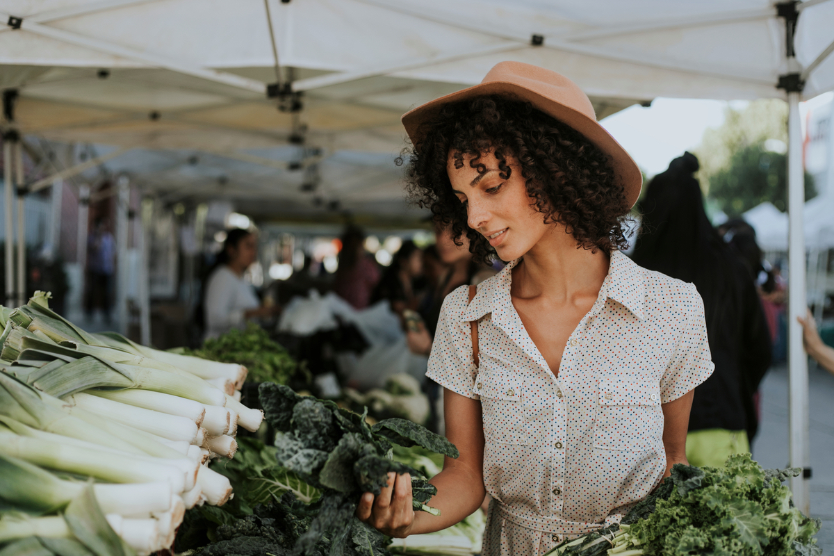 A woman shops for leafy greens