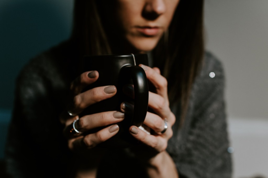 A woman holds a tea cup