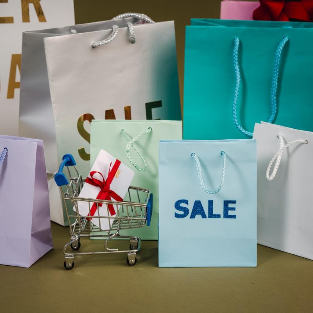 A bunch of shopping bags on a table.