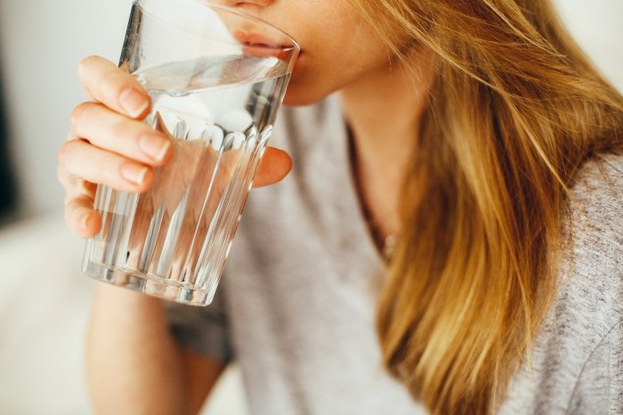 woman-drinking-water-gray-t-shirt