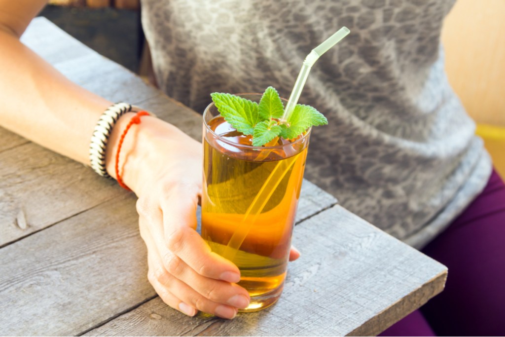 A woman drinking kombucha