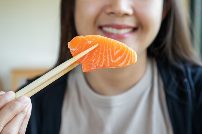 A woman eats brain-healthy salmon