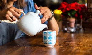 A woman pours tea