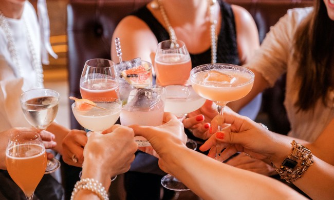 A group of friends toasting with cocktails