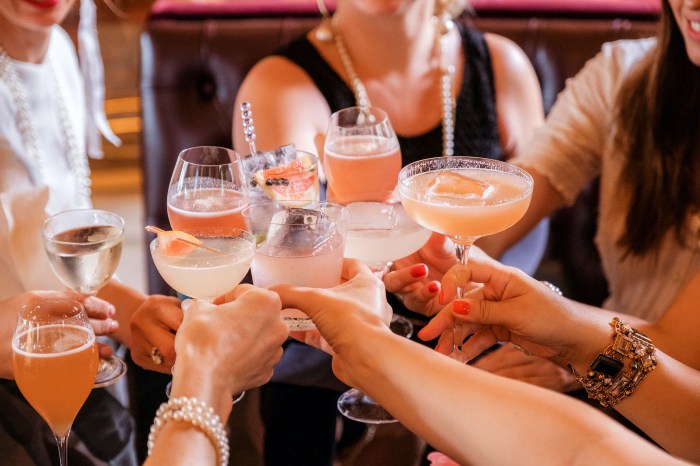 A group of friends toasting with cocktails