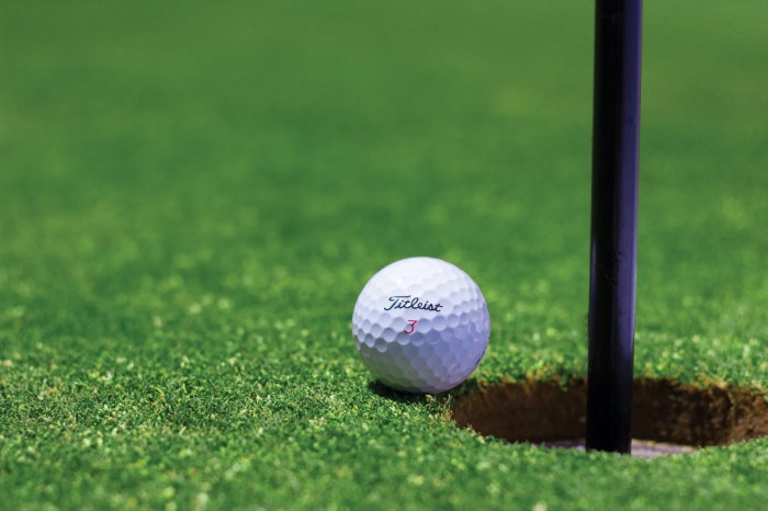 golf-ball-near-hole-on-green